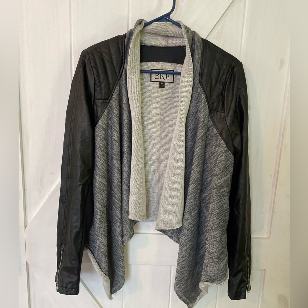 Biker style, buckle, open sweatshirt/coat. Leather details make this super cute!